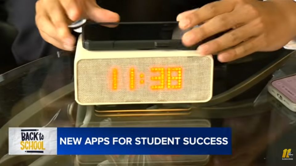 Aveira One on a glass table with a phone docked on top, from the ABC 11 segment 'New Apps for Student Success'